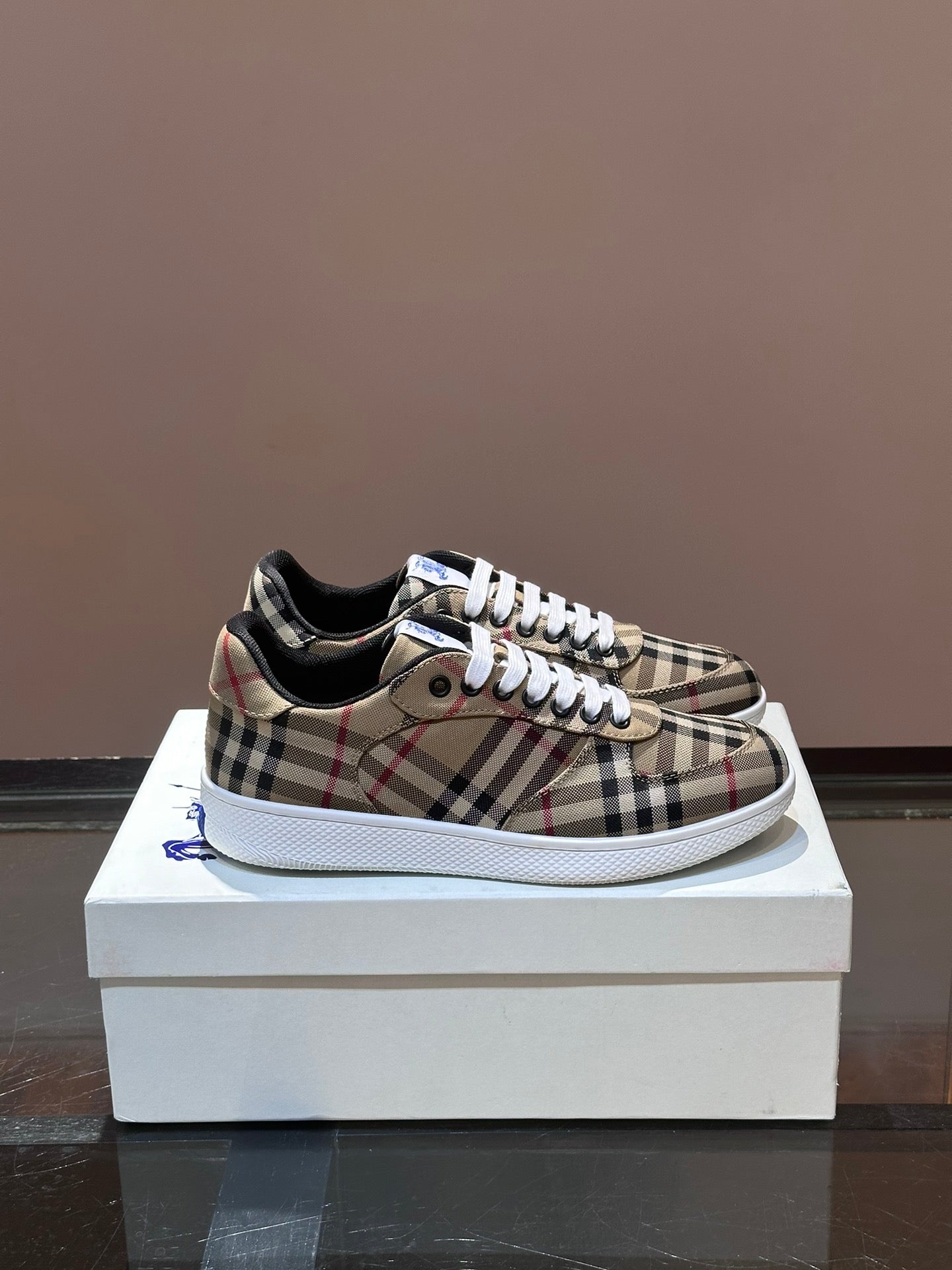 Checkered low-top sneakers with white laces and blue accent, rubber sole