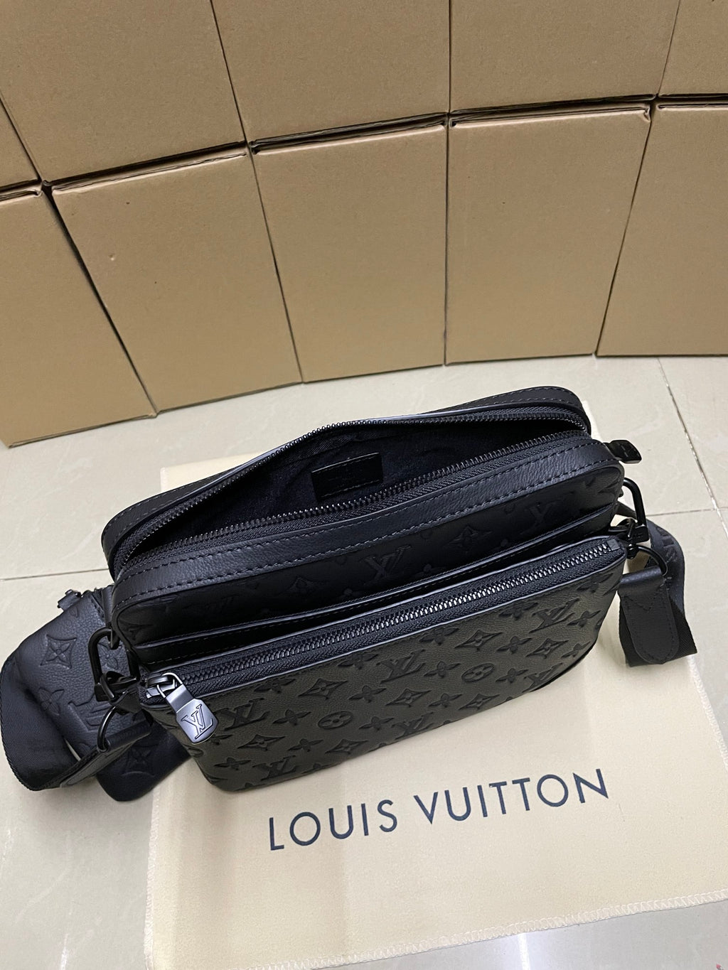 Men's Louis Vuitton crossbody bag, dark blue monogram, front view with dual zip and strap