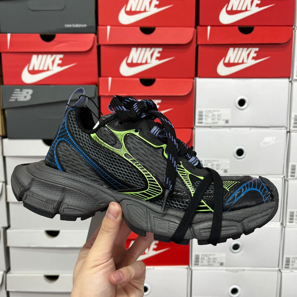 Unisex running shoes on display, black and gray with neon green and blue accents, lace-up.