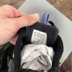Unisex shoe tongue label with size text inside, black lining with blue pull tab.