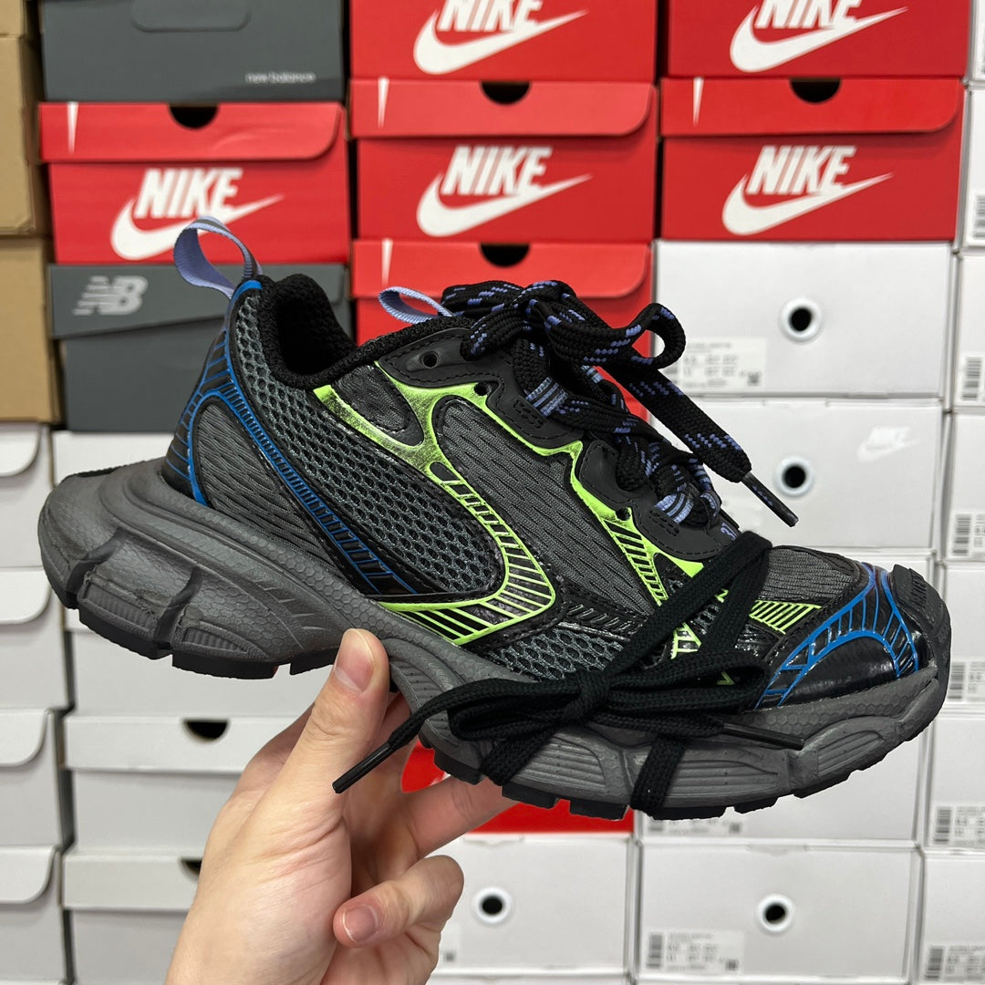 Unisex running shoe in black and gray with neon green and blue accents, lace-up.