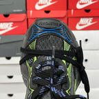 Unisex shoe upper heel close-up with black mesh and knit, neon green and blue accents.