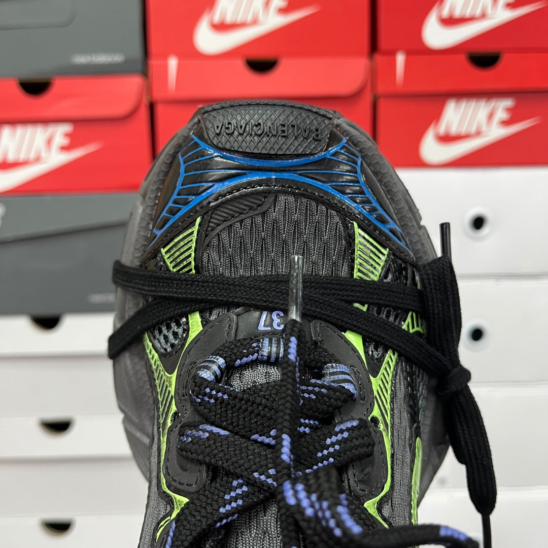 Unisex shoe upper heel close-up with black mesh and knit, neon green and blue accents.