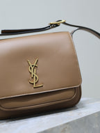 Tan leather flap bag with gold YSL logo and stitched edges