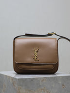 Tan leather crossbody bag with gold YSL logo on front flap