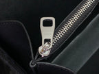 Louis Vuitton bag zipper pull with logo tag and silver hardware on dark leather