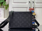 Men's Louis Vuitton bag with adjustable shoulder strap and studded frame
