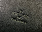 Men's Louis Vuitton bag embossed logo text on textured black fabric