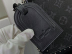 Men's Louis Vuitton bag close-up of embossed leather label and black textured exterior