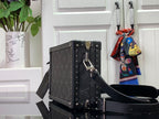 Men's Louis Vuitton bag with top handle, studded corners, front lock and side strap
