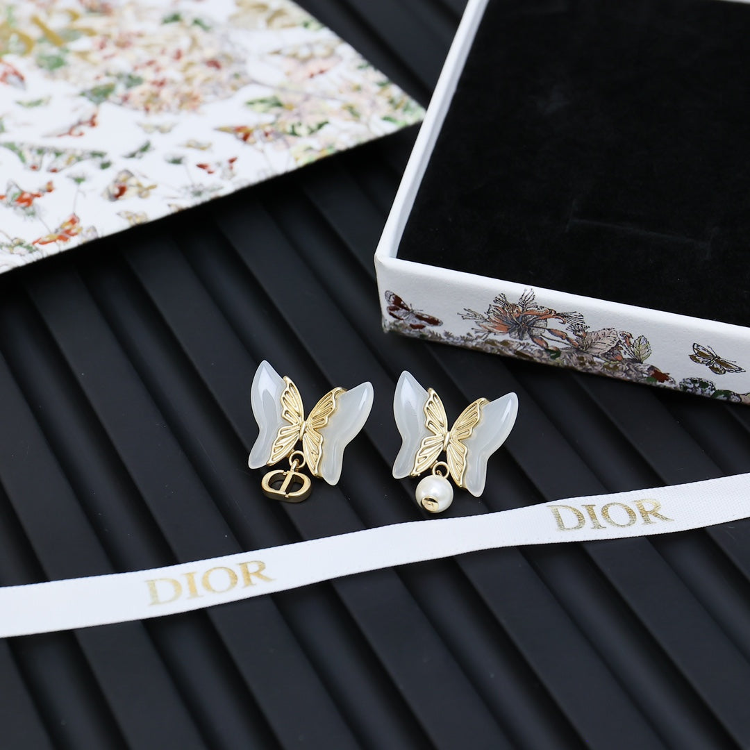 Butterfly earrings with faux pearl drops on white Dior box