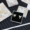 Butterfly earrings with faux pearl and gold-tone Dior logo drop charm