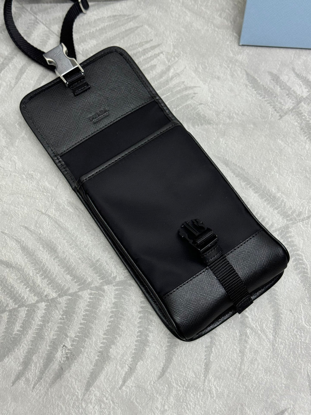 Prada black mini bag with embossed logo panel and adjustable strap