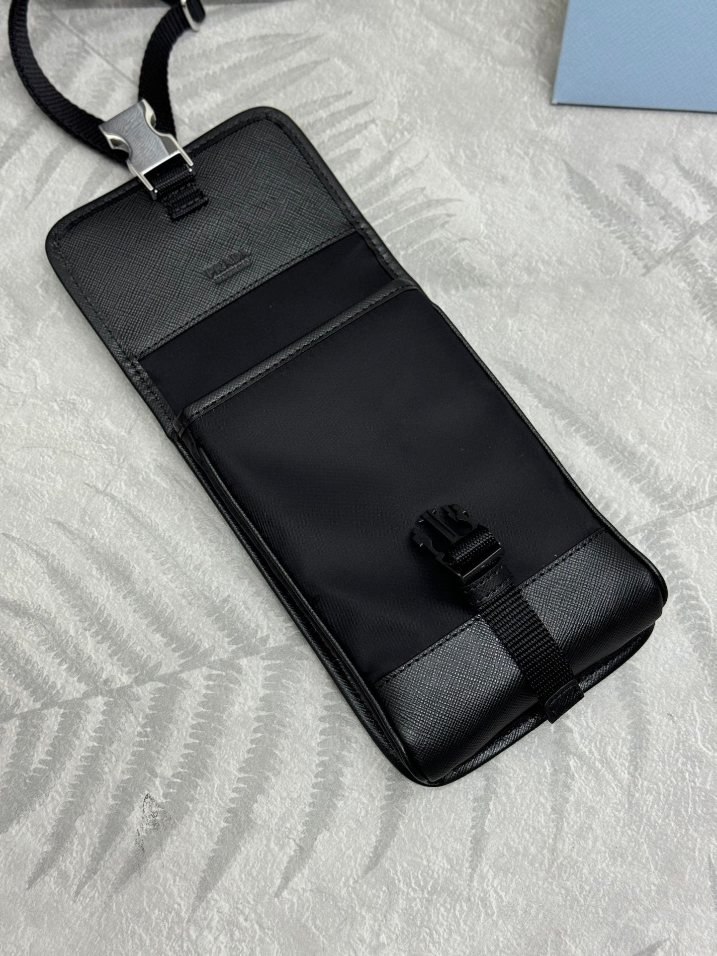Prada black mini bag with embossed logo panel and adjustable strap