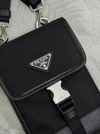 Prada black mini bag close-up of front logo plaque and strap buckle