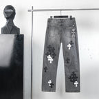 Chrome pants in gray denim with cross patch graphics and a small hanging charm