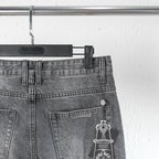 Chrome pants back pocket close-up with coin/button hardware and hanging charm