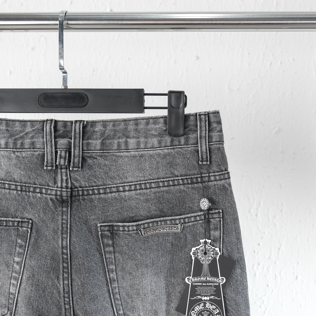 Chrome pants back pocket close-up with coin/button hardware and hanging charm