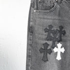 Chrome pants leg close-up with embroidered cross designs and white cross patch
