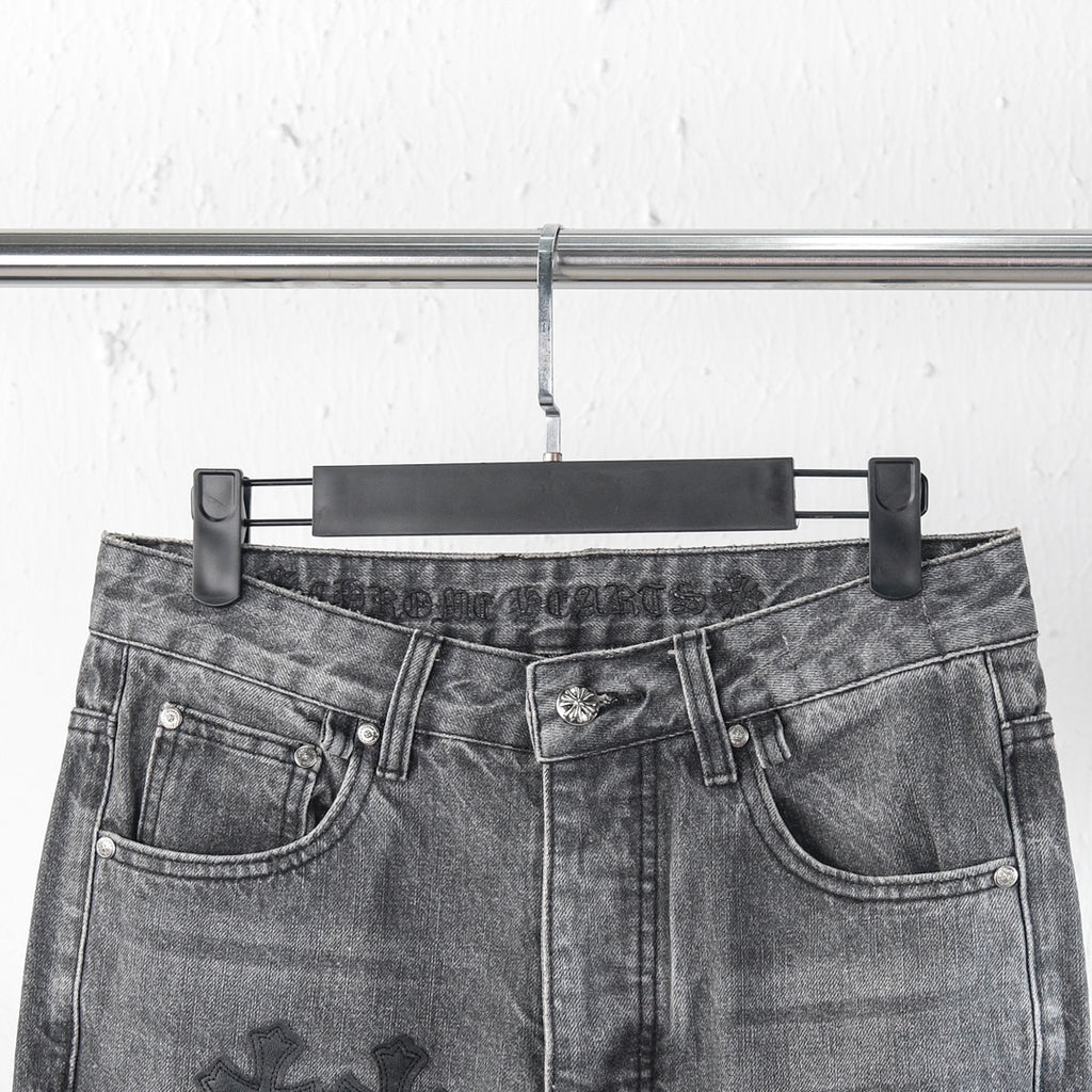 Chrome pants close-up of waist with belt loops and button fly; cross patch details