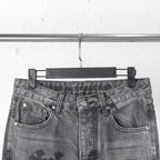 Chrome pants close-up of waist with belt loops and button fly; cross patch details