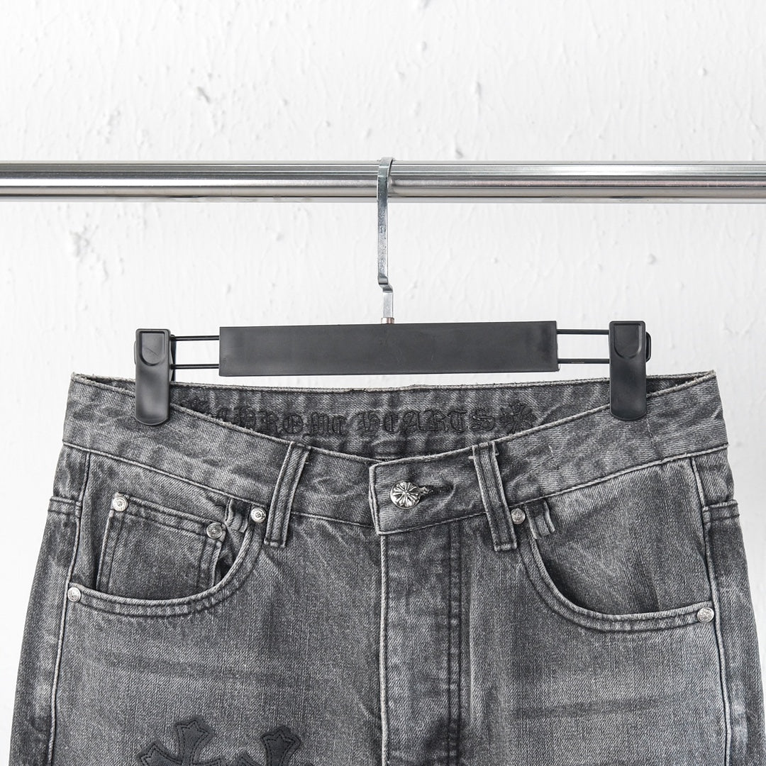 Chrome pants close-up of waist with belt loops and button fly; cross patch details