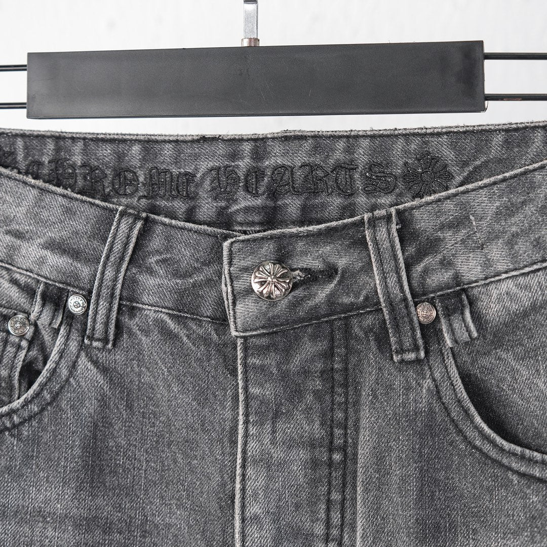 Chrome pants waist close-up with buttoned closure and metal flower belt detail