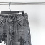 Chrome pants leg close-up with side pocket and cross patch graphic in dark denim