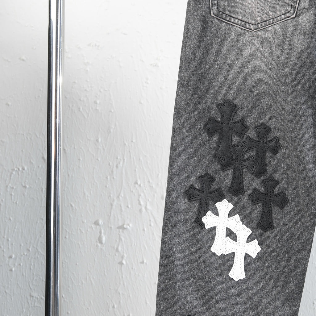 Chrome pants leg detail with dark and white cross appliques near the knee