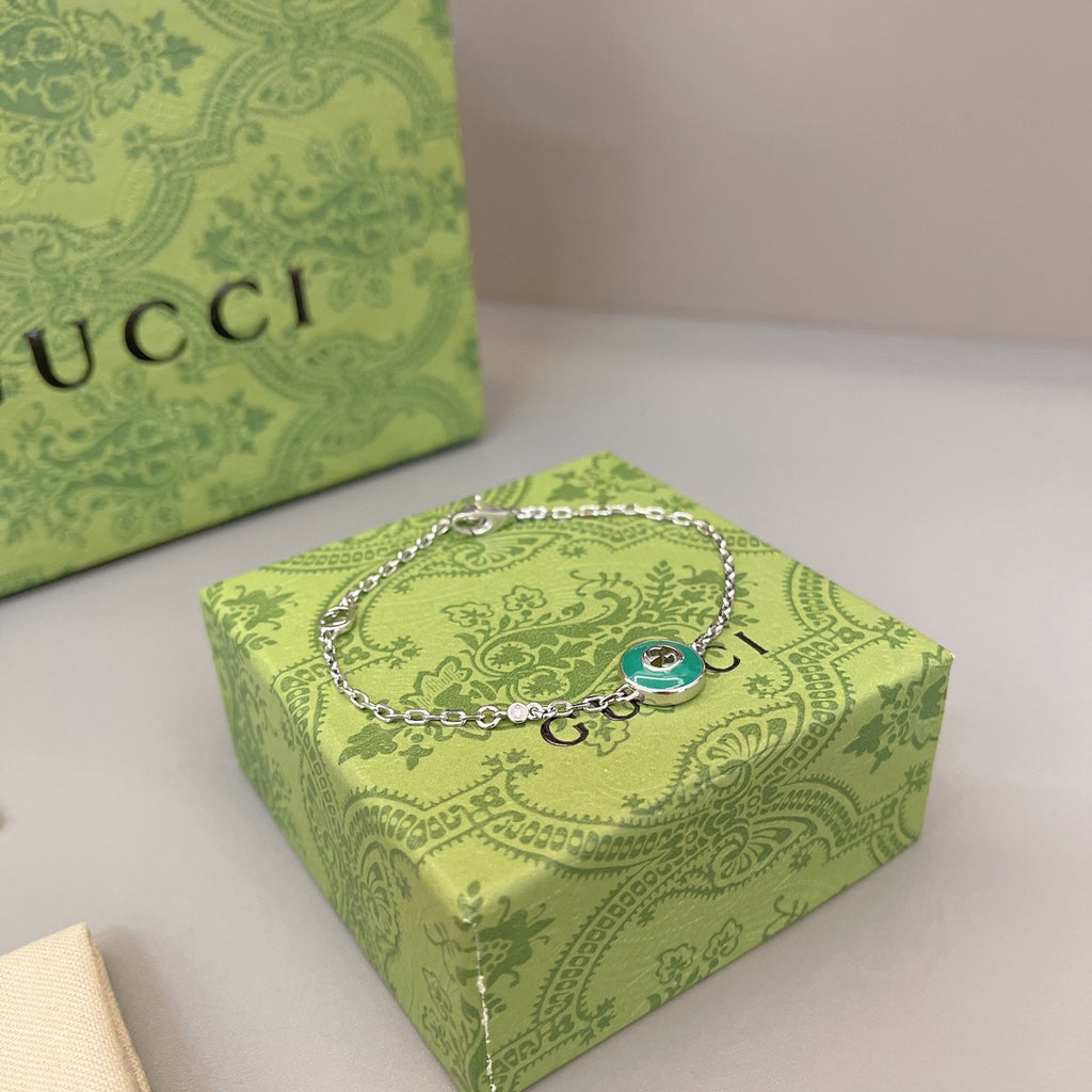 Gucci silver bracelet with green enamel charm on chain