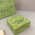 Gucci silver bracelet with green enamel charm on chain