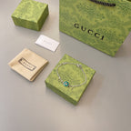 Gucci bracelet with green enamel charm, shown with dust bag and gift boxes