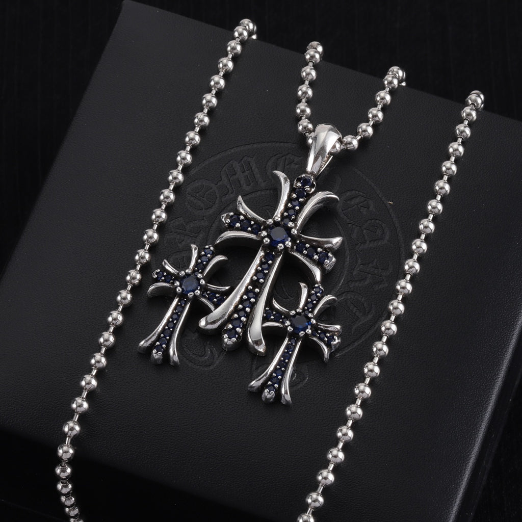 Single pendant necklace with chrome cross charm, dark enamel and small stones