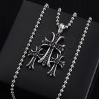 Single pendant necklace with chrome cross charm, dark enamel and small stones