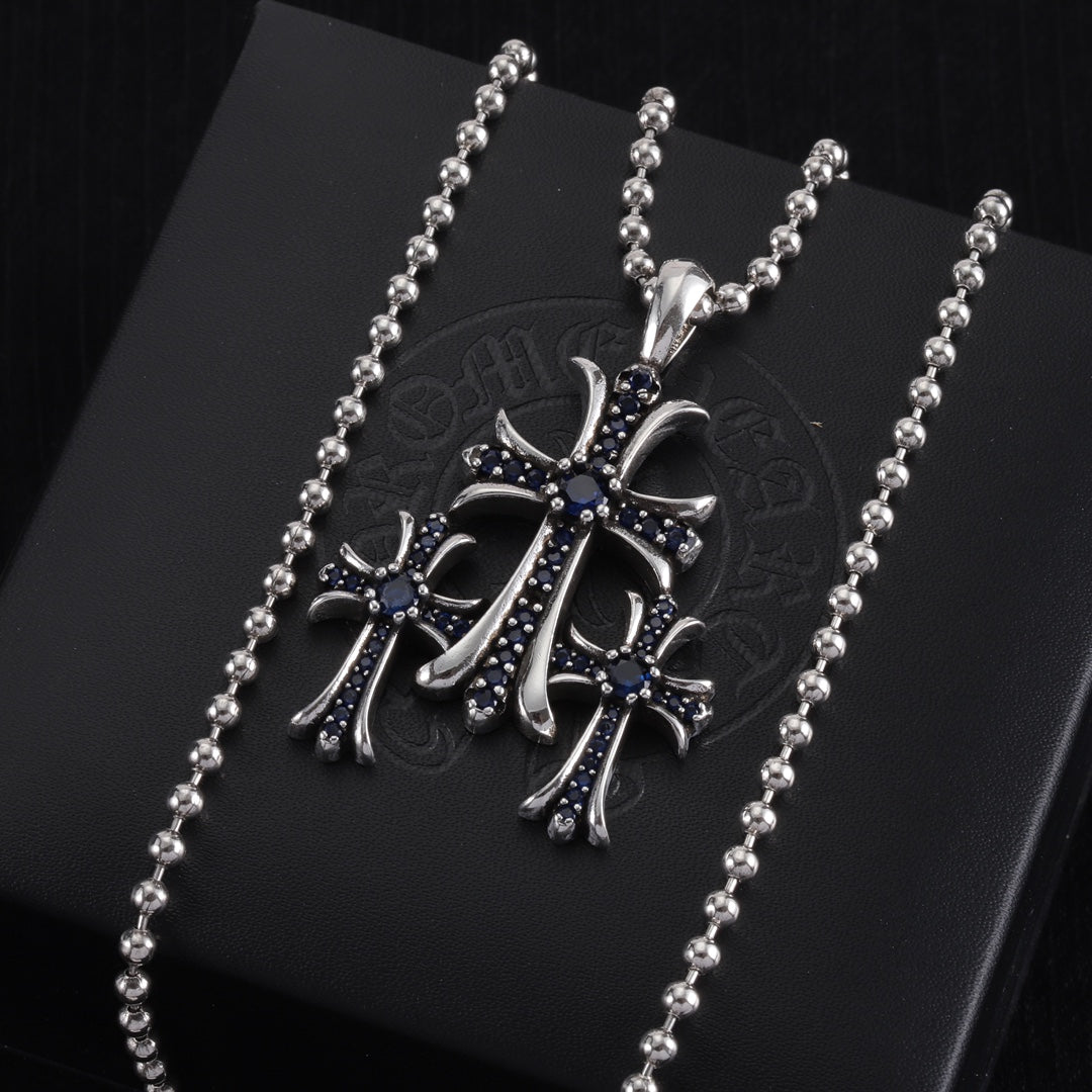 Single pendant necklace with chrome cross charm, dark enamel and small stones