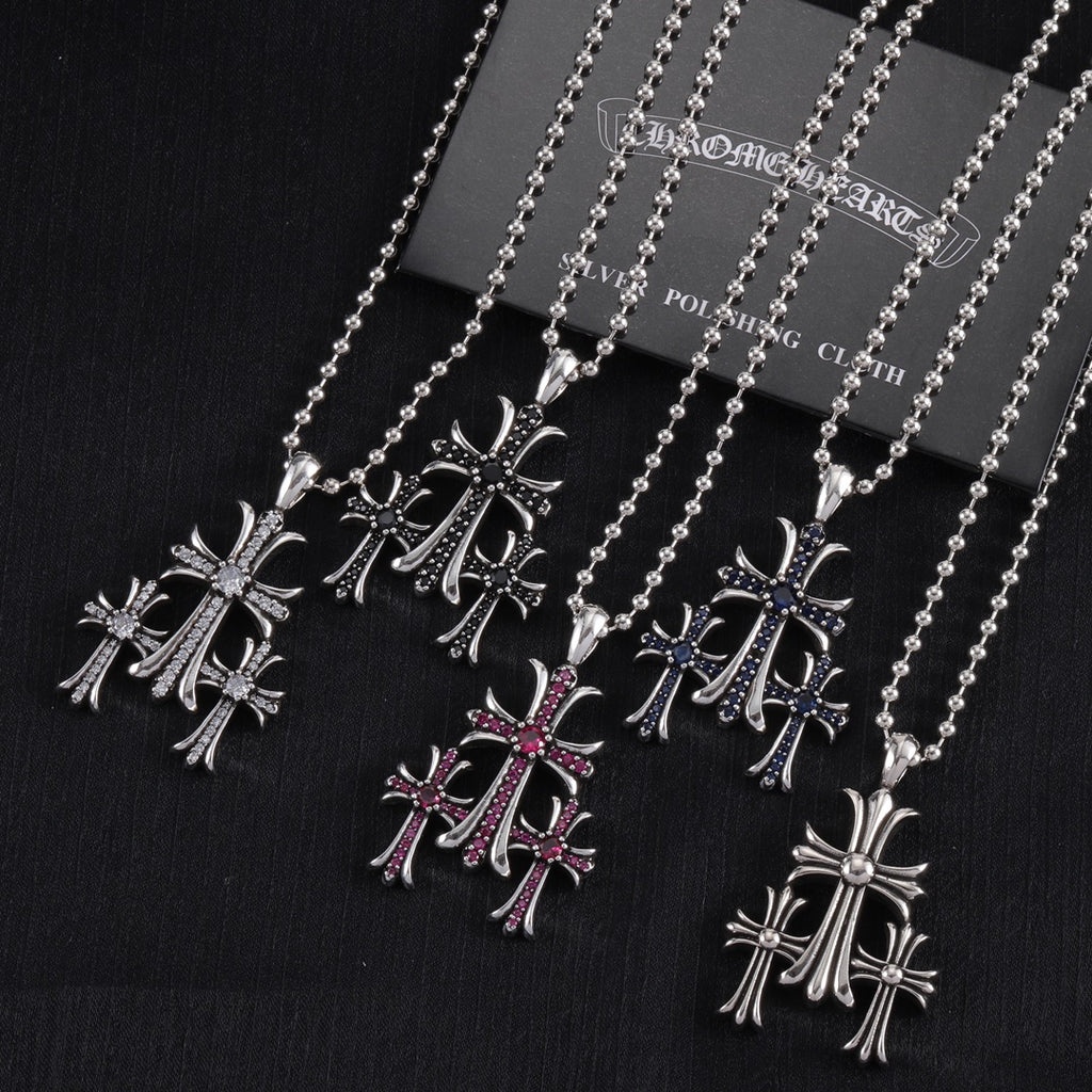 Chrome-toned pendant necklaces with cross motifs, red and blue enamel accents