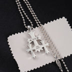 Chrome pendant necklace with snowflake-like charm, engraved 925 and 2020