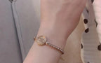 Chanel round logo bracelet on wrist with pearl-bead chain detail