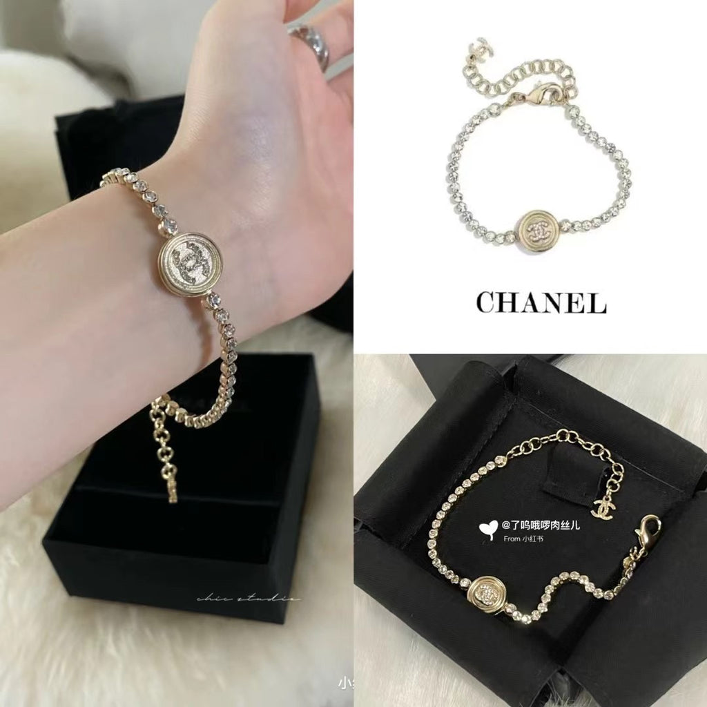 Chanel bracelet on hand with pearl beads and round logo medallion center