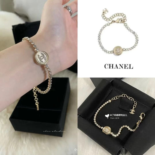 Chanel bracelet on hand with pearl beads and round logo medallion center