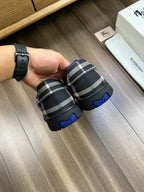 Burberry lace-up sneakers, heel view, black check fabric with blue sole trim