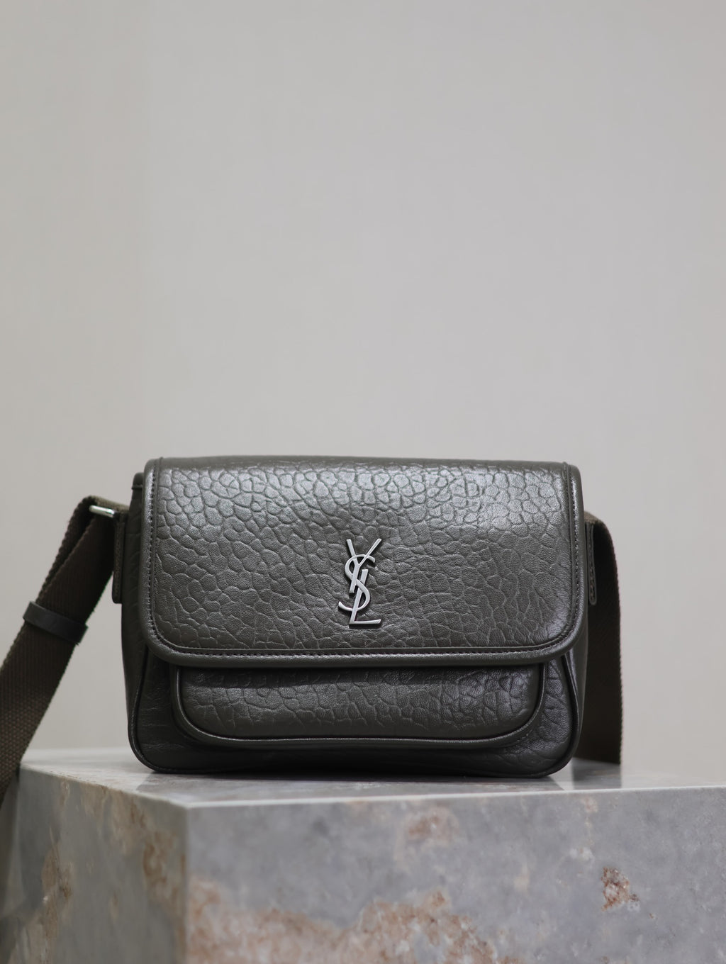 YSL flap crossbody bag in black textured leather, with silver logo on front