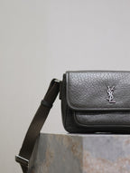 YSL flap crossbody bag side view with adjustable strap and textured leather finish