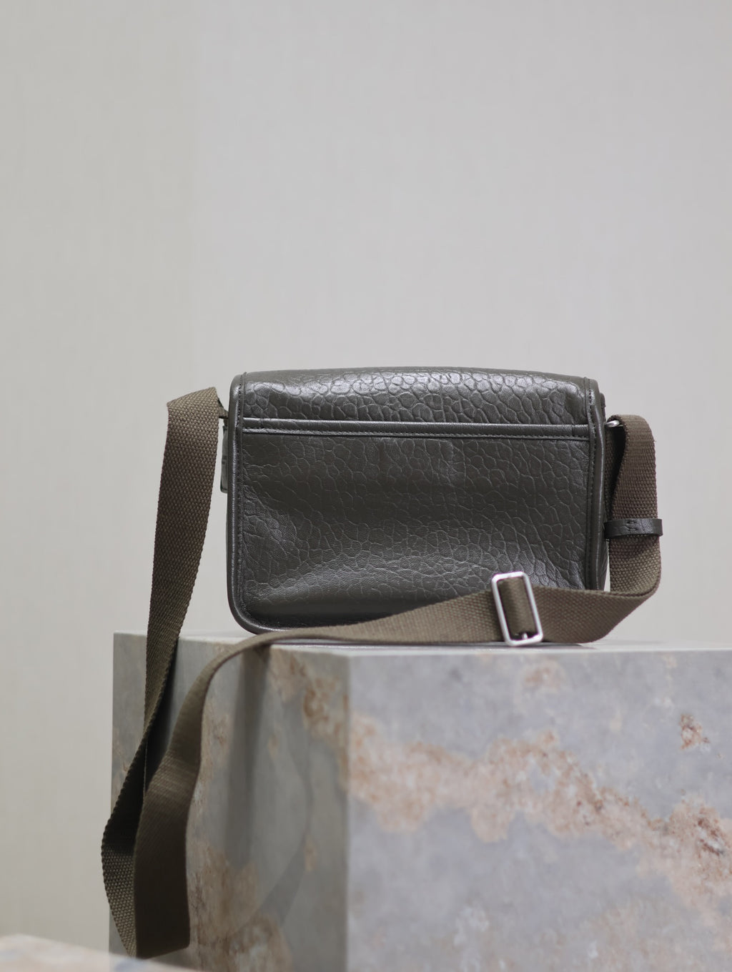 YSL crossbody bag side view with adjustable strap buckle and top stitching