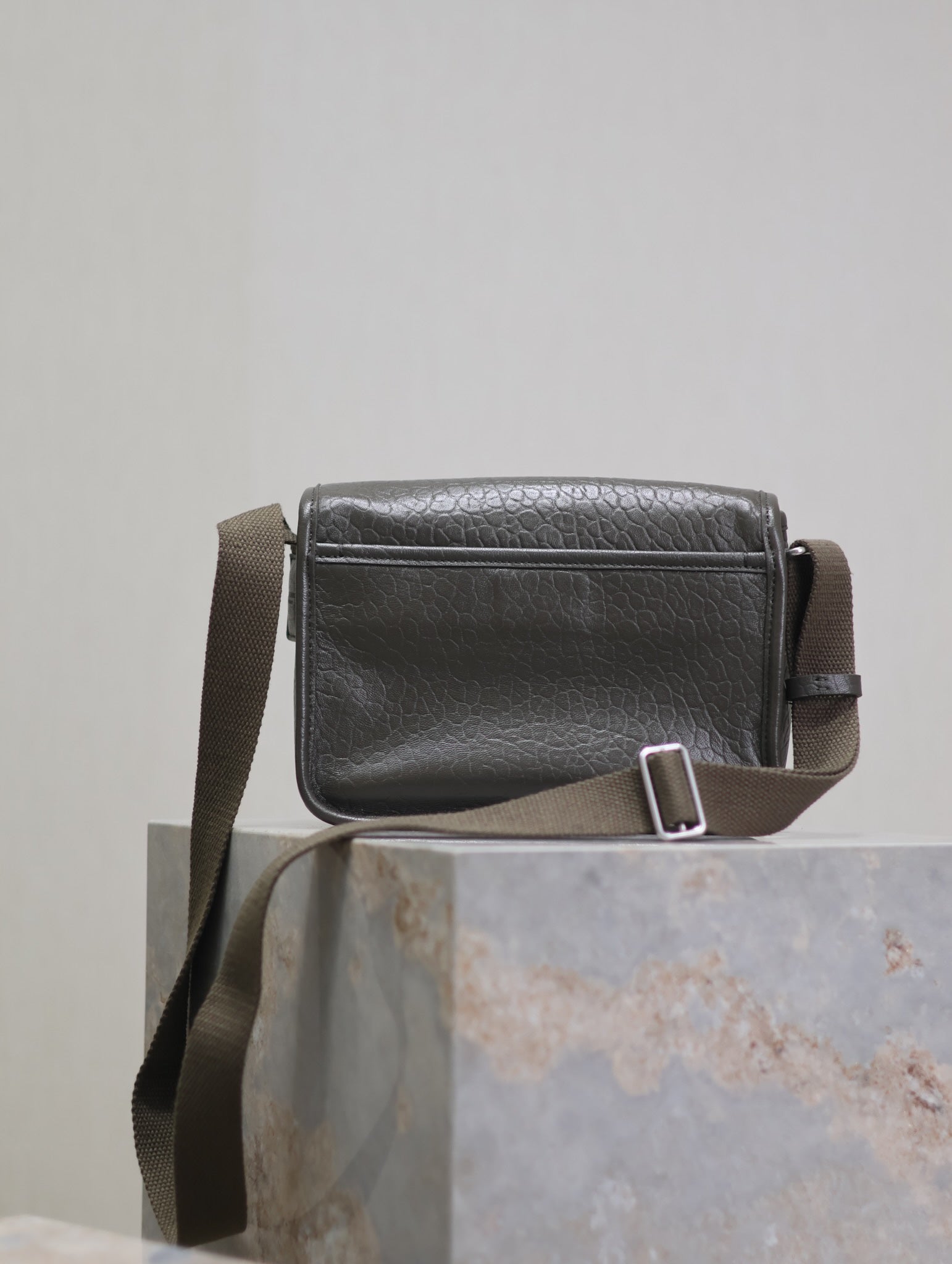 YSL crossbody bag side view with adjustable strap buckle and top stitching