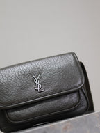 YSL flap crossbody bag close-up of textured flap with silver YSL logo