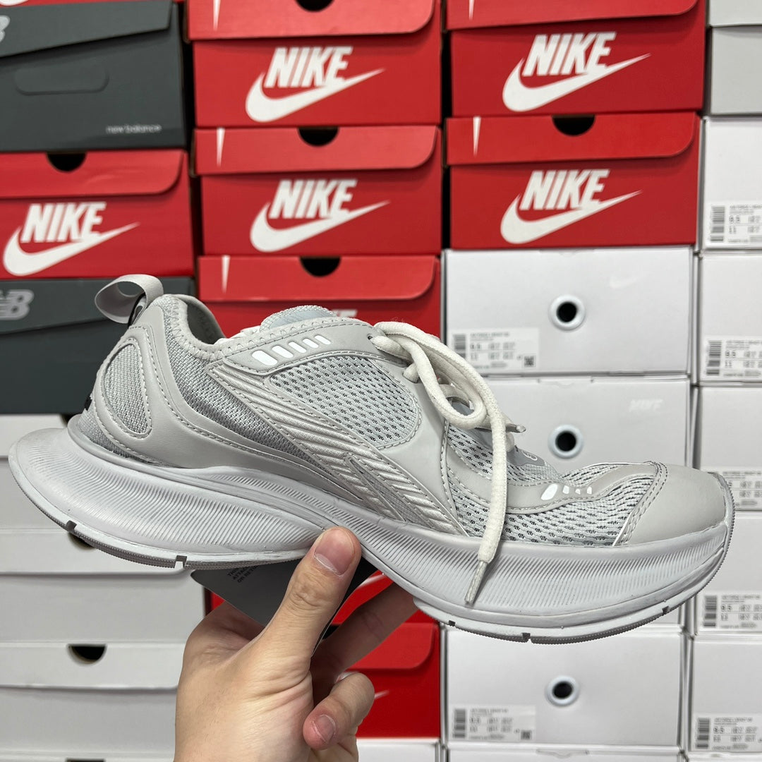 Pair of light gray lace-up running shoes with knit upper and cushioned sole