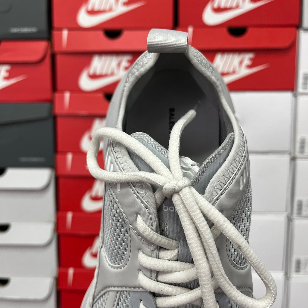 Light gray lace-up shoe with padded tongue and mesh side panels