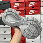Light gray shoe outsole view with patterned traction tread