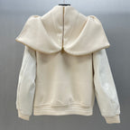 Cream hooded jacket back view with cape-like shoulders and ribbed hem